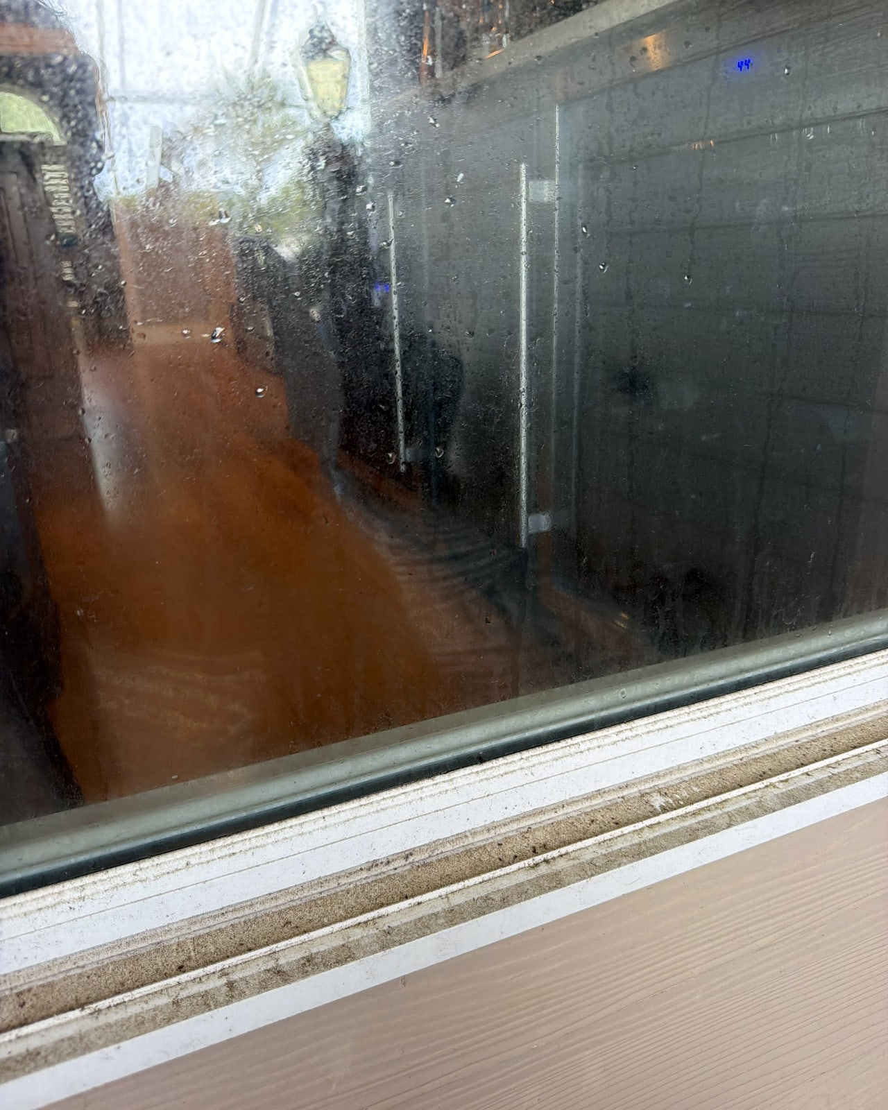 Interior glass with heavy spots and haze before cleaning.